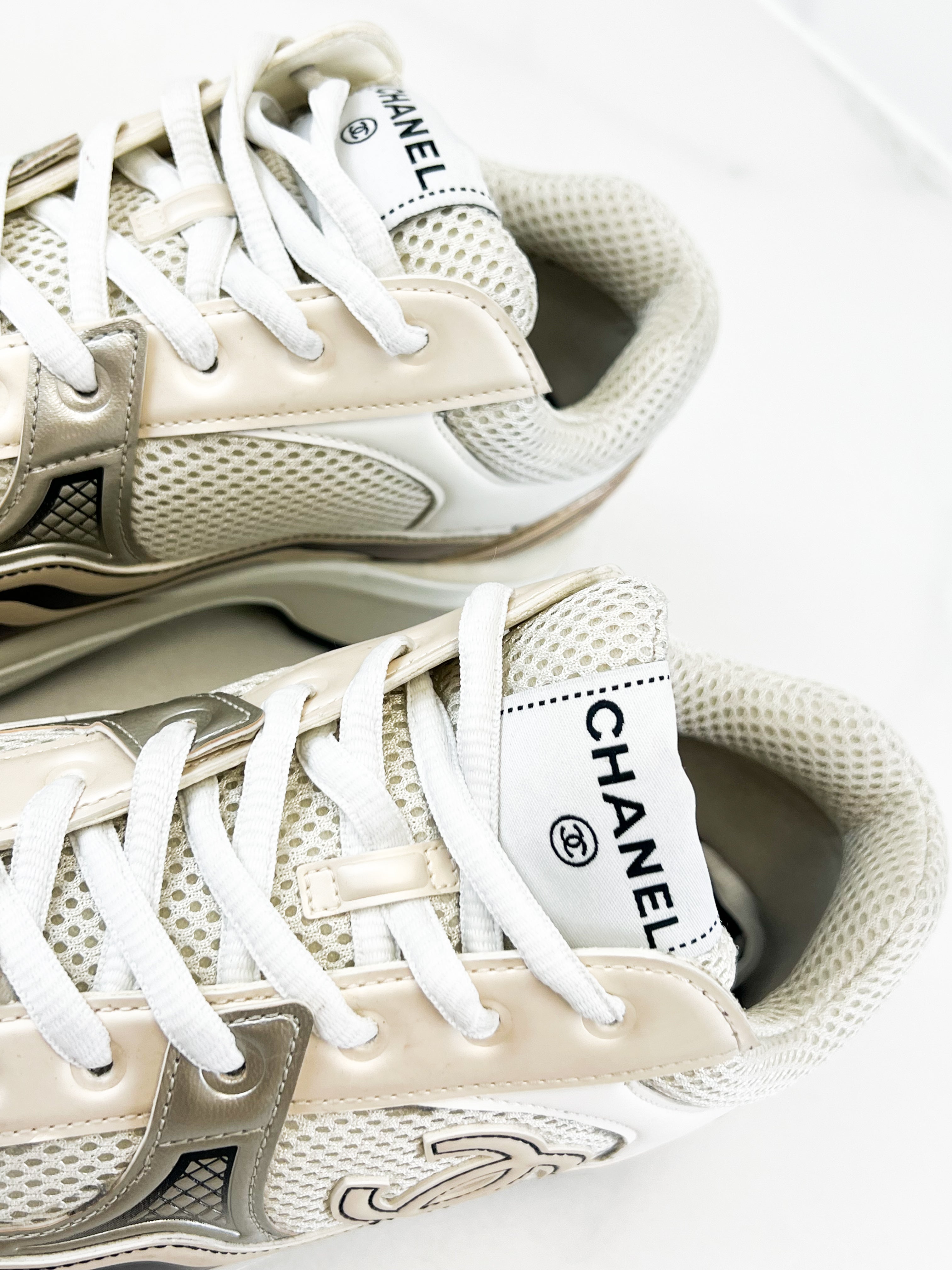 Chanel Laminated Leather and Fabric CC Low Top Sneakers In Ivory, White & Silver Size 39.5