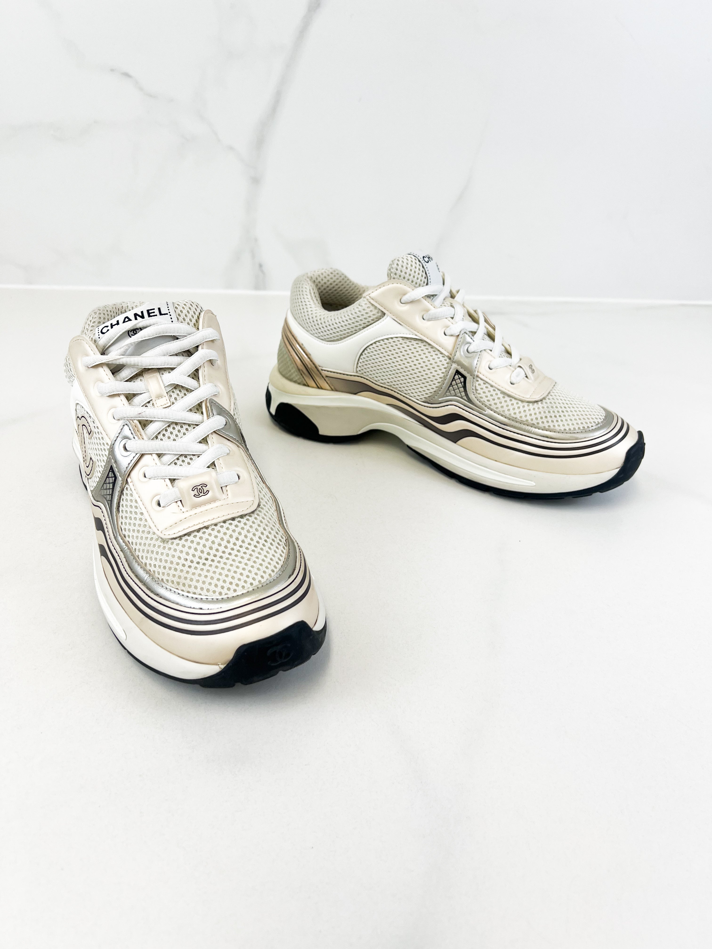 Chanel Laminated Leather and Fabric CC Low Top Sneakers In Ivory, White & Silver Size 39.5